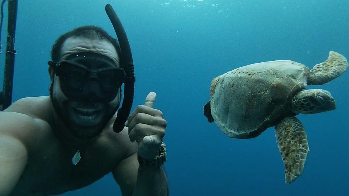 Local fisherman establishes trust on a rare encounter with a turtle